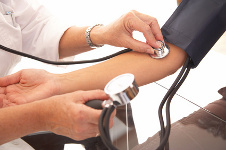 female doctors hand checking blood pressure with stethoscope